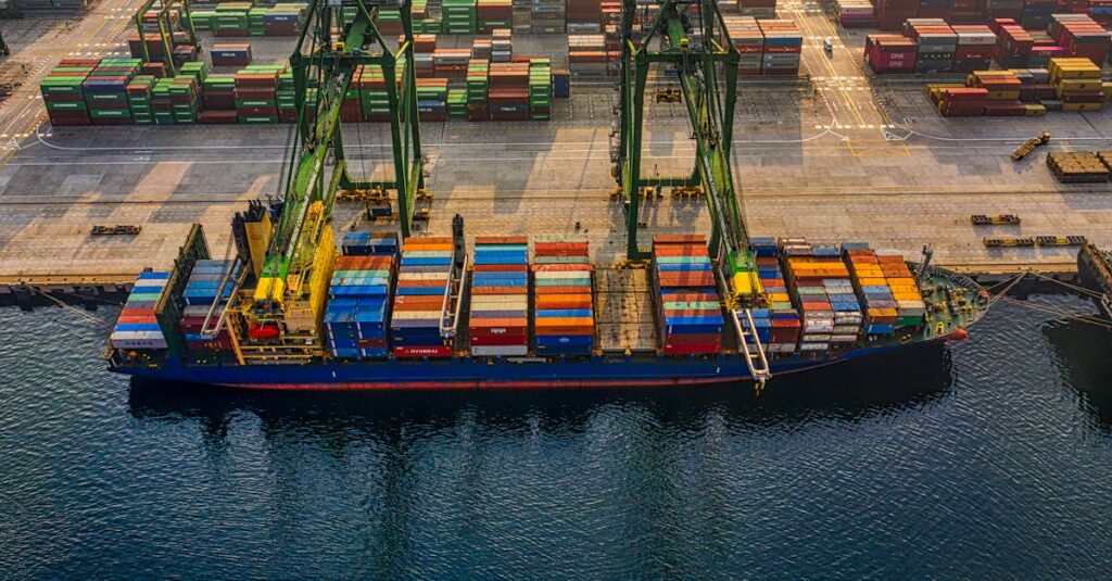 Aerial shot of colorful shipping containers at North Jakarta's bustling port, Indonesia.