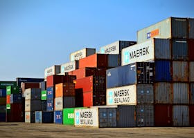 Colorful stacked shipping containers at a port exemplify global logistics.